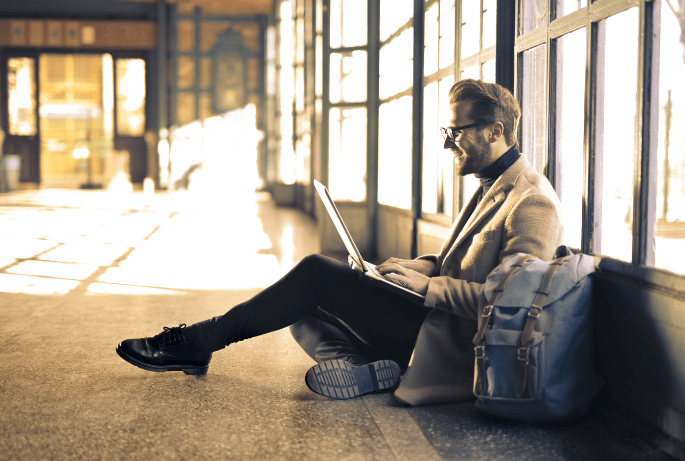 A man with a notebook on the floor