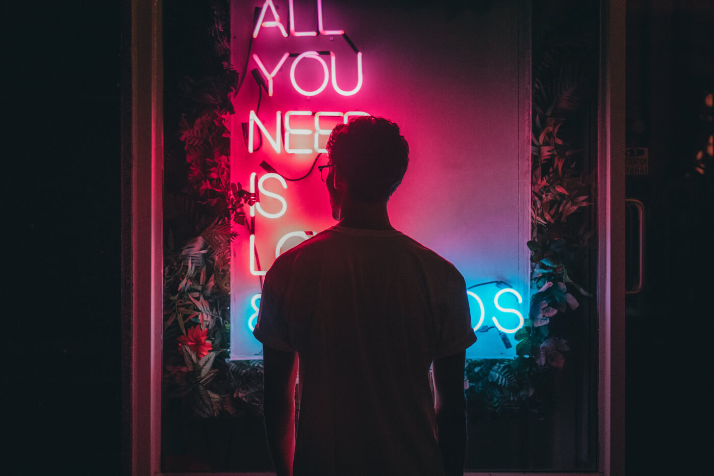 a neon sign 'what you need is'