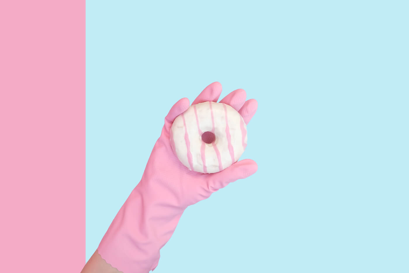 a hand holding a donut