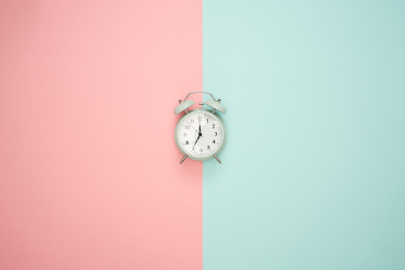 a clock on blue and pink background